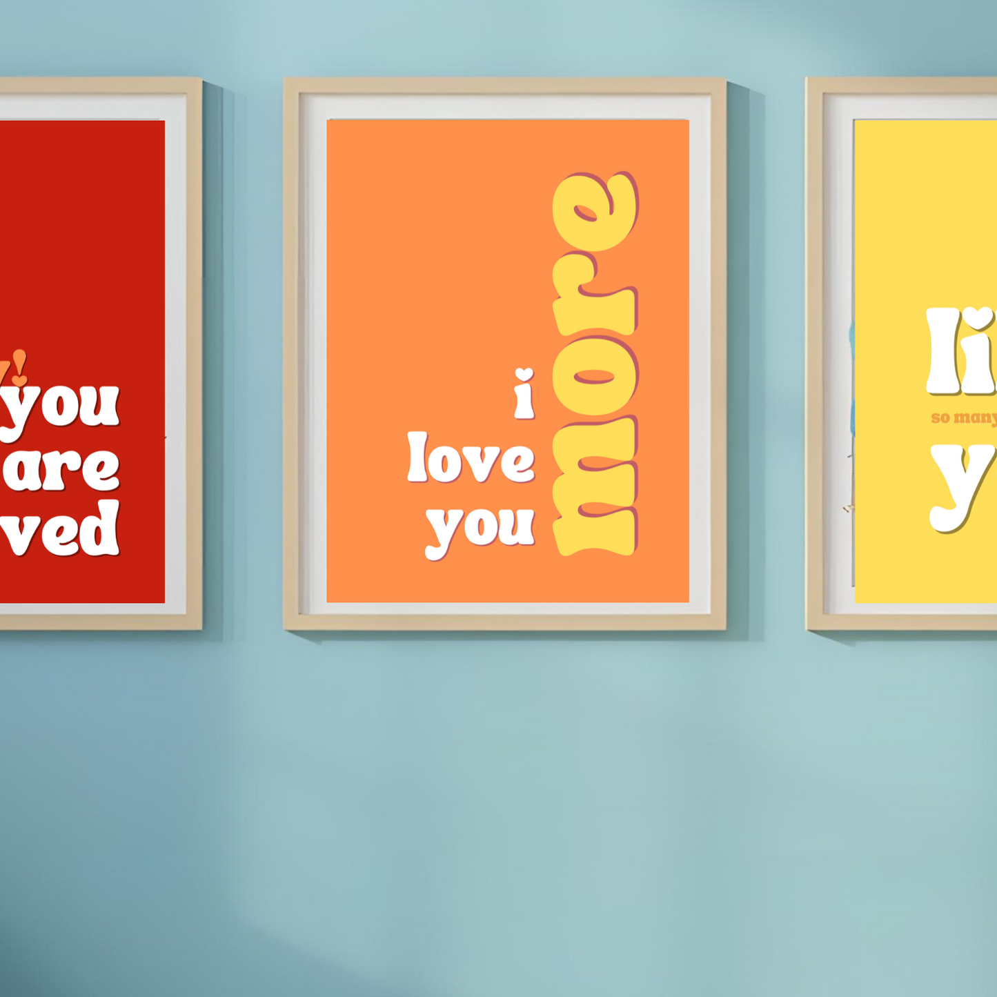 Three framed posters with motivational text on a blue wall.