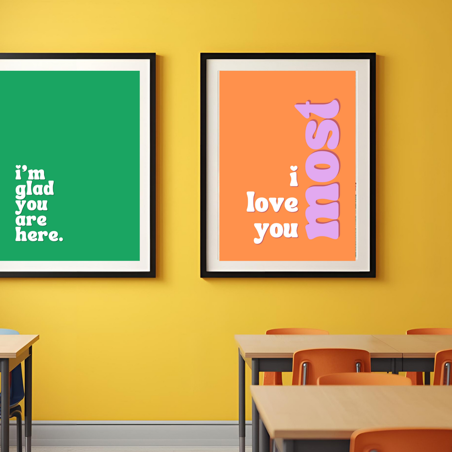 Two framed posters on a yellow wall with classroom furniture below.
