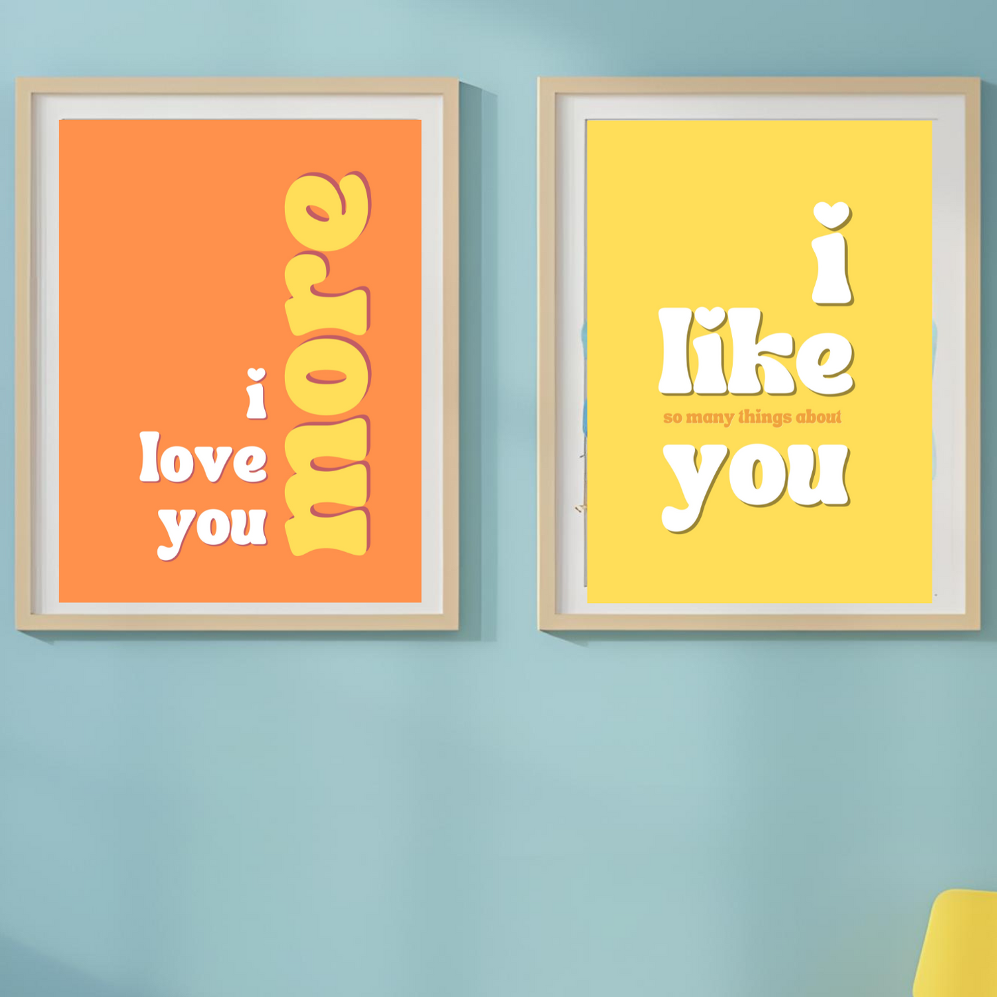 Three framed posters with motivational text on a blue wall.