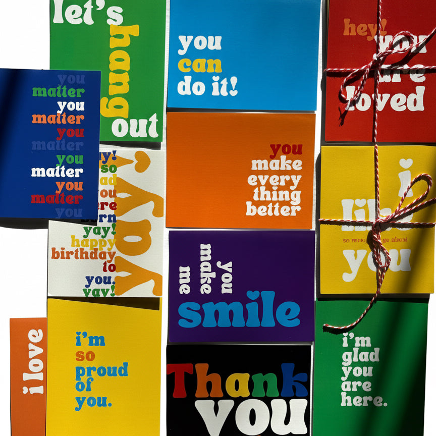 Colorful greeting cards with various messages on a polka dot fabric background