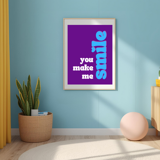 Framed poster with 'you make me smile' text in a room with a blue wall, yellow cabinet, and potted plant.
